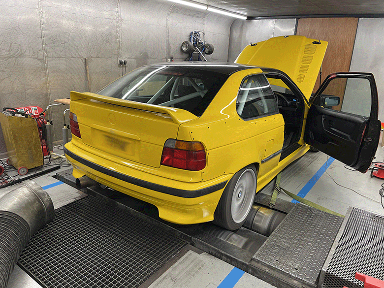 Yellow BMW e36 compact on the dyno during tuning